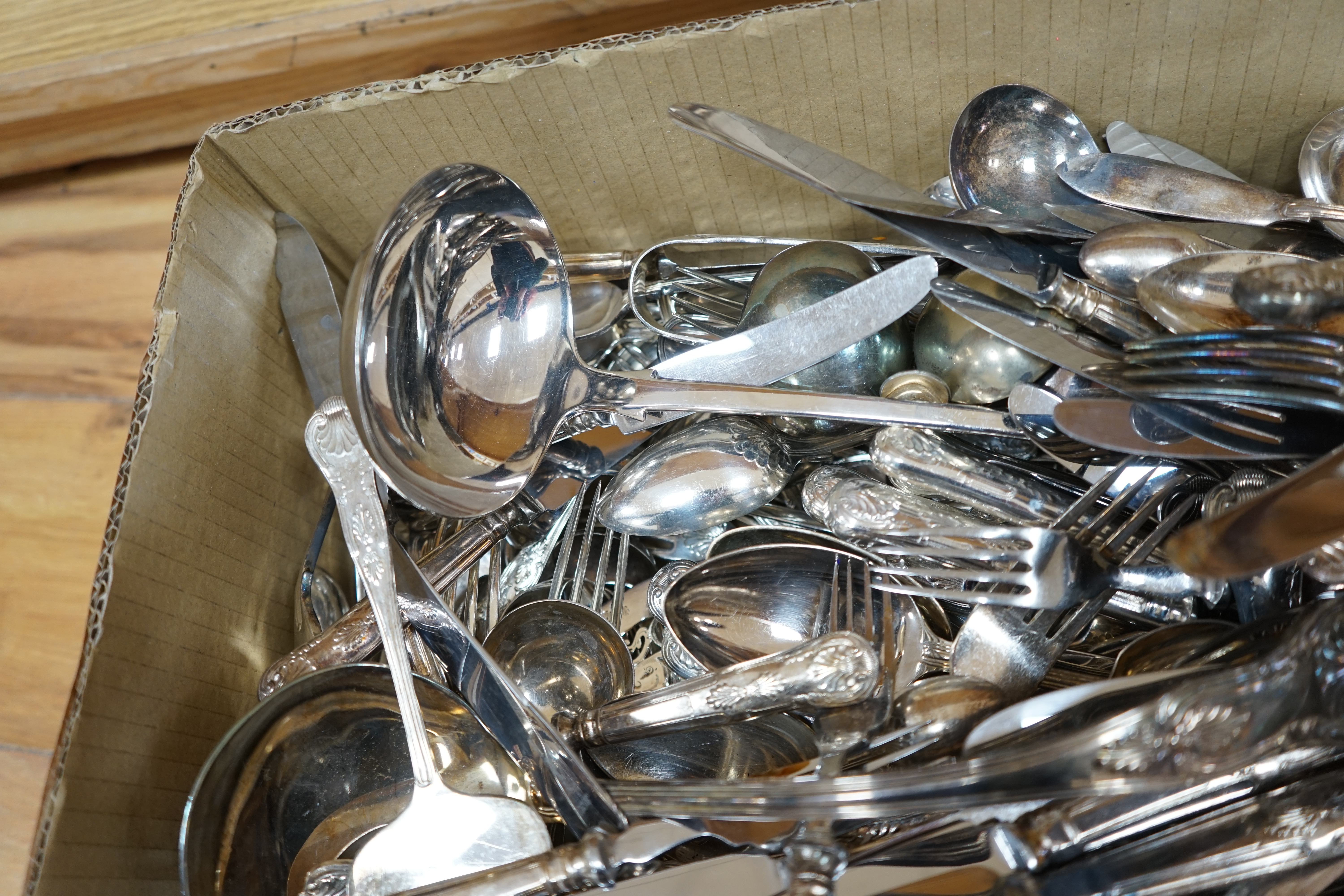 A large quantity silver plated cutlery including a part canteen of King's pattern cutlery and beaded pattern cutlery, a plated sugar basket, together with a mahogany, velvet lined box, 38cm wide. Condition - fair